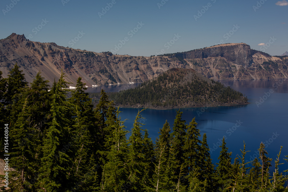 Mesmerizing Crater Lake, with its deep blue waters reflecting the snow-capped peaks of Mount Mazama, a captivating natural wonder nestled in the Cascade Mountains of Oregon.