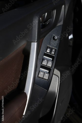 black interior of a modern car. Dashboard. Luxury leather steering wheel. Auto controls. Car doors inside. Car chairs and seats. Car sofa. Back and front row. Interior and door trim. High quality © Vitalii