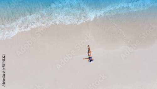 Fresh of summer with young woman relaxation as lying on the beach in Maldives