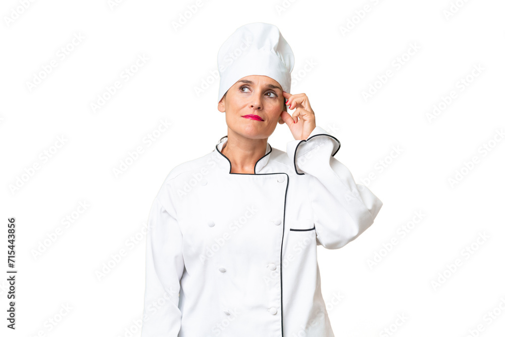 Middle-aged chef woman over isolated background having doubts and with confuse face expression Middle-aged chef woman over isolated background having doubts and with confuse face expression
