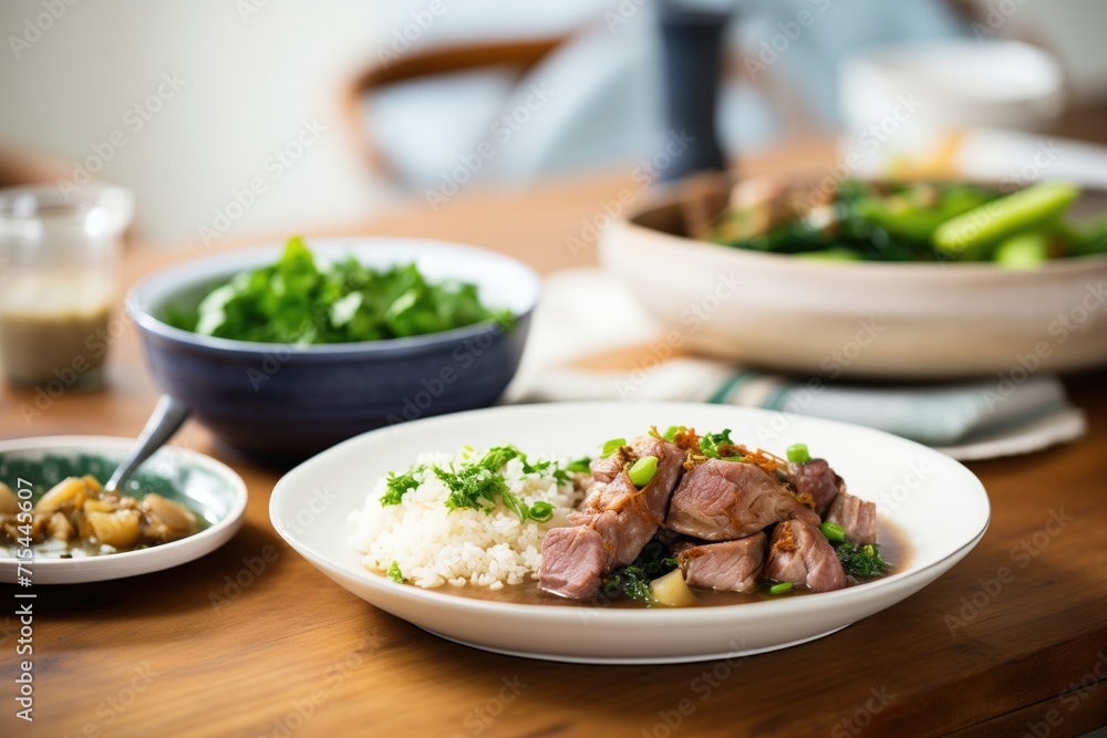 plated feijoada with slices of pork, visible bean stew plated feijoada with slices of pork, visible bean stew