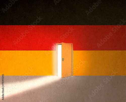 German flag with light of opportunity behind ajar door to immigrate in Germany photo