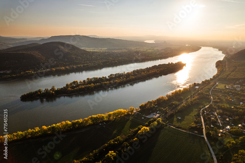 Obraz na plátne Top view of river shore, surrounded by forest with sand coastline, beach