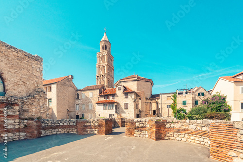 Croatia, Split-Dalmatia County, Split, Stone wall of Triclinium with houses and tower of Cathedral of Saint Domnius in background photo
