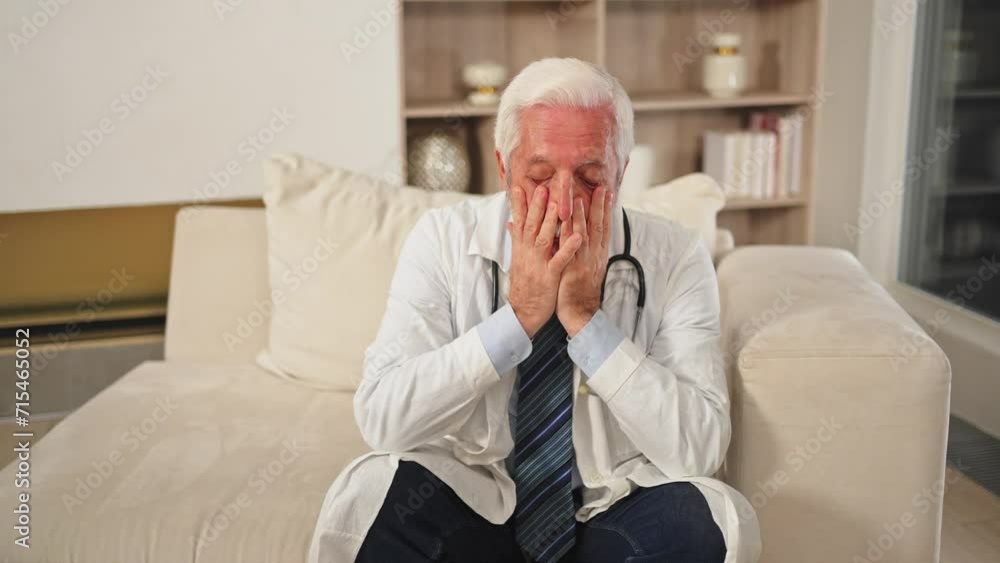 Sad tired mature senior male doctor in medical uniform in hospital or doctor office. Unhappy General Practitioner GP therapist professional healthcare expert in clinic. Healthcare concept Sad tired mature senior male doctor in medical uniform in hospital or doctor office. Unhappy General Practitioner GP therapist professional healthcare expert in clinic. Healthcare concept