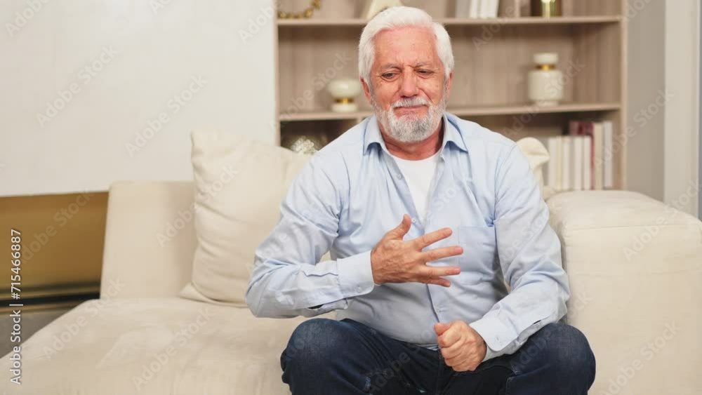 Pain on heart, heart attack. Unhappy middle aged senior man suffering from chest pain heart attack problems with health at home. Mature old senior grandfather touching chest experiencing infarction Pain on heart, heart attack. Unhappy middle aged senior man suffering from chest pain heart attack problems with health at home. Mature old senior grandfather touching chest experiencing infarction