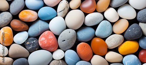 Close up of colorful beach pebbles vibrant hues and smooth textures in sunlight