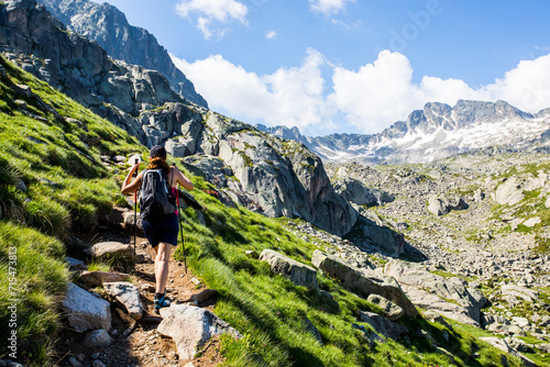 Young hiker girl summit to Ratera Peak in Aiguestortes and Sant Maurici National Park, Spain photo