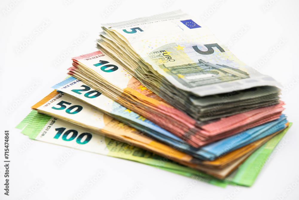 Pile of euro banknotes of 100, 50, 20, 10 and 5 euros. White background Pile of euro banknotes of 100, 50, 20, 10 and 5 euros. White background