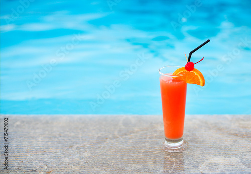 Glass of tropical cocktail on poolside