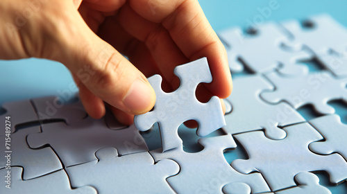 Teamwork Puzzle Challenge: A conceptual image of hands connecting puzzle pieces, representing teamwork and problem-solving