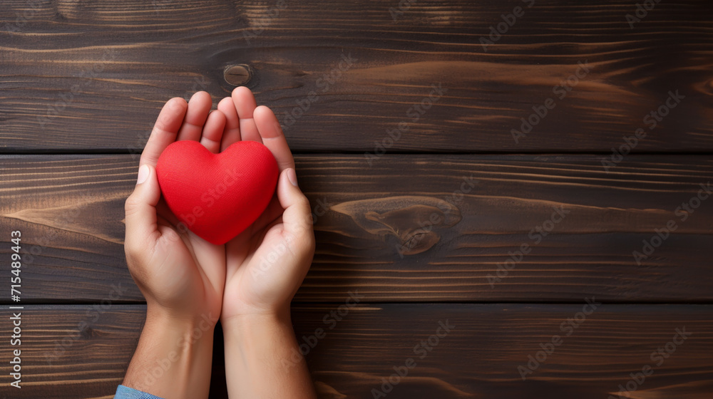 Top view photo of hands holding red heart on black background, healthcare, love, organ donation, mindfulness, wellbeing, family insurance and CSR concept, World Heart Day. Top view photo of hands holding red heart on black background, healthcare, love, organ donation, mindfulness, wellbeing, family insurance and CSR concept, World Heart Day.