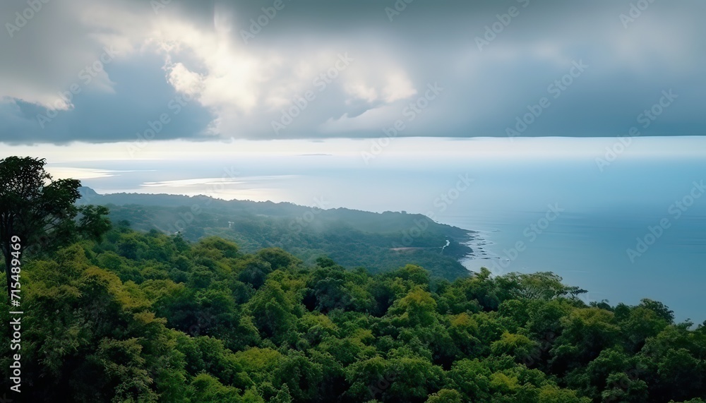 View of the sea of clouds from the top of the mountain peak before storm. Tropical rainforest. View of the sea of clouds from the top of the mountain peak before storm. Tropical rainforest.