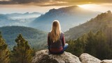 Woman sitting on a rock enjoying the view, mountains, travel, fog 