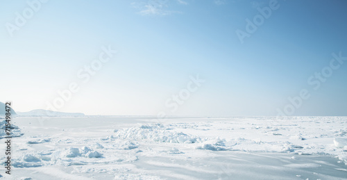 Winter landscape - frozen sea surface with snow. © Vladimir Arndt