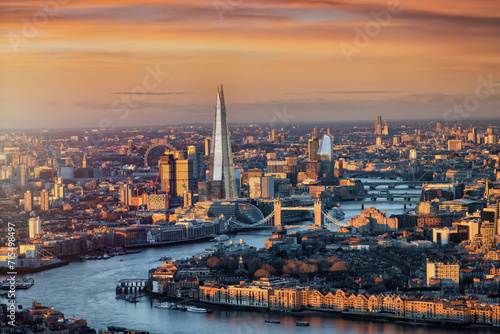 Panoramic sunrise view of the London skyline with Tower Bridge and river Thames in soft sunlight, England photo