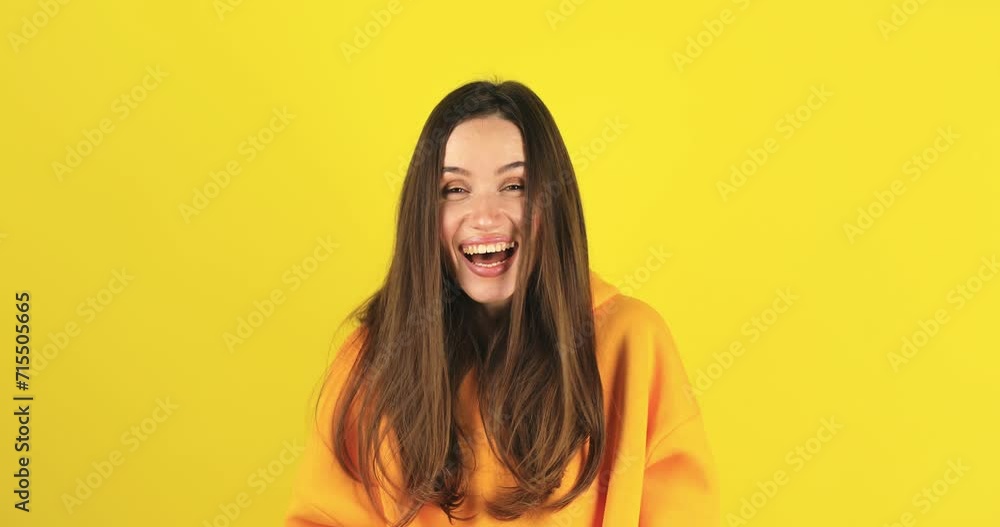 Amazed excited woman hairstyle in yellow hoody open mouth in surprise looking at camera with big eyes, shocked isolated on yellow background. Oh my god wow, yes gesture, win symbol.