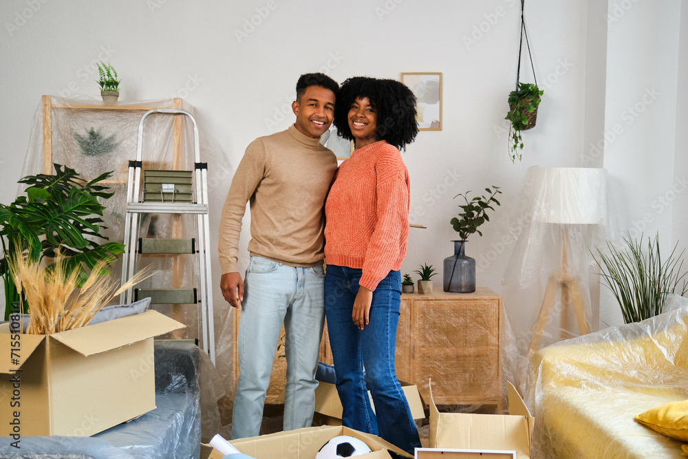 Portrait of happy young black moving in a new home. New residence relocation. Portrait of happy young black moving in a new home. New residence relocation.