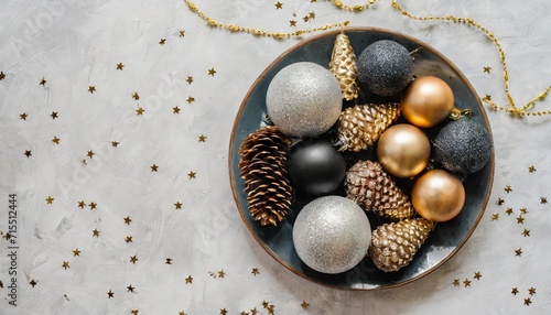 background with christmas decorations glass gold black silver decorative cones on plate on d white marmur background minimalistic style still life top view