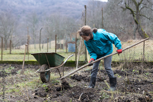 Adult Woman Doing Farmer's Preparatory Work in Garden in Winter