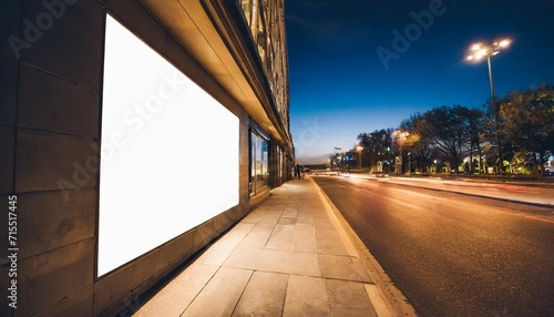 blank white advertising billboard on a office building wall at night mockup © Marcelo