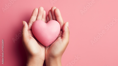 Attractive brunette young Asian woman feels happy and romantic shapes heart gesture expresses tender feelings photo