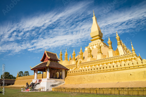 Fotografija Beautiful large golden pagoda Pha That Luang temple famous landmark in Vientiane, Laos PDR sunny day blue sky background