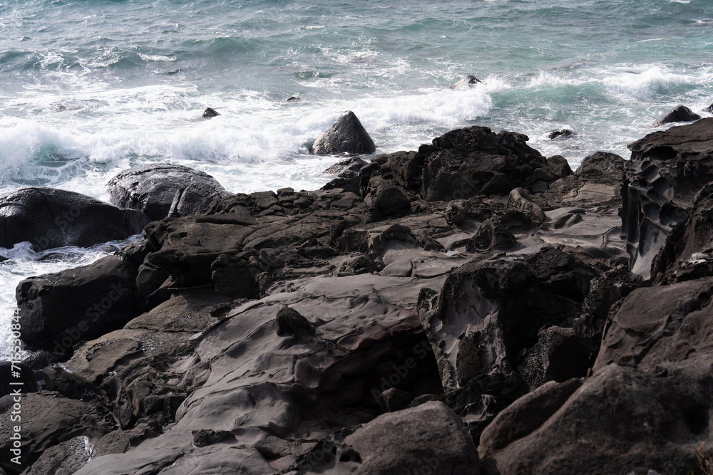 waves crashing on rocks at the seaside
