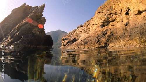 Slow motion underwater and then over water video of coastal rocks. Crete. photo