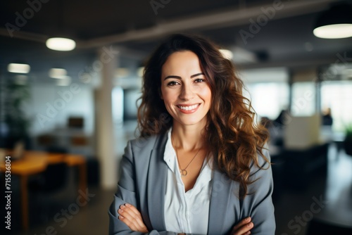Happy confident businesswoman in office looking at camera
