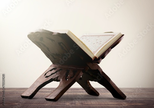 Open Holy Quran book on wooden table