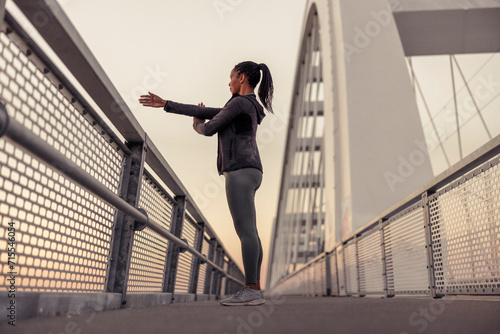 Woman warming up for morning jogging session