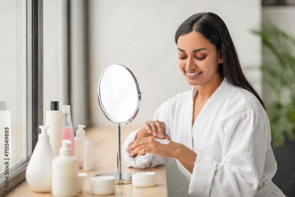 Pretty indian woman enjoying her morning body care routine Pretty indian woman enjoying her morning body care routine