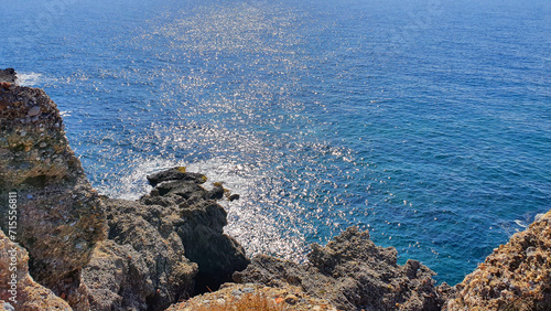 Blue sky and rock beach by the sea .