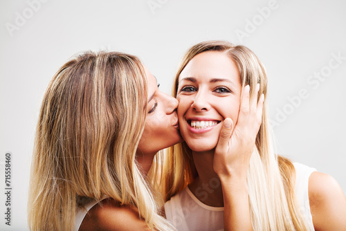 Affectionate peck on cheek between friendly women