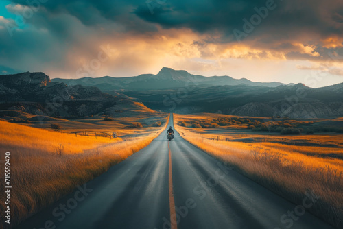 A person driving down a road in a landscape