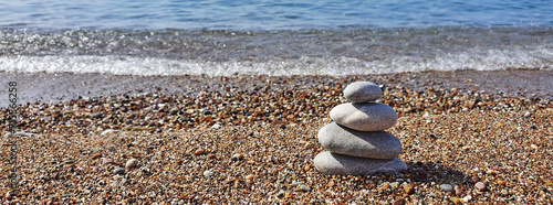 Photography Spa stones balance on the sand of the beach.