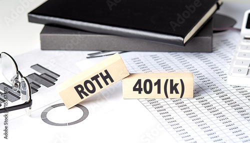 ROTH 401K - text on a wooden block with chart and notebook