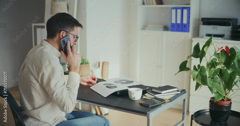 Businessman Talking On Mobile Phone While Sitting On Chair Businessman Talking On Mobile Phone While Sitting On Chair