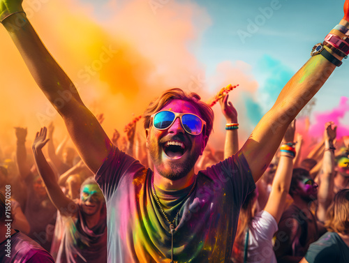 Happy man in a crowd and with colorful powder paint, holi festival celebration 