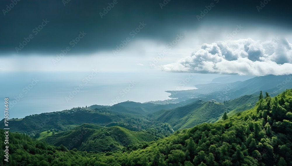 View of the sea of clouds from the top of the mountain peak before storm. Tropical rainforest.