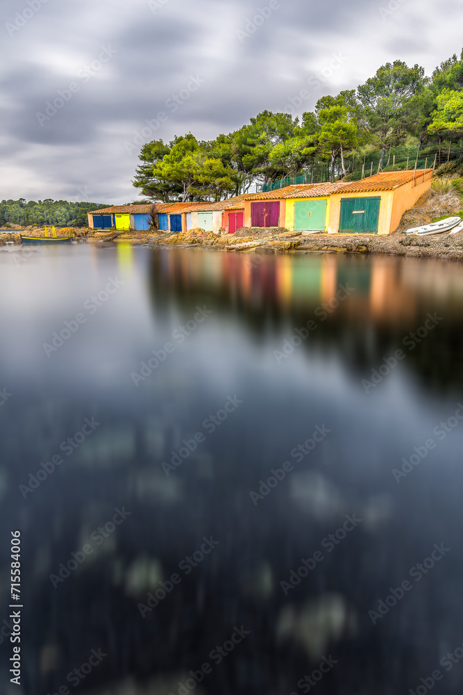 Fototapeta premium Scenic view of colored boat shelters in south of France on rainy cast during winter near Saint Tropez