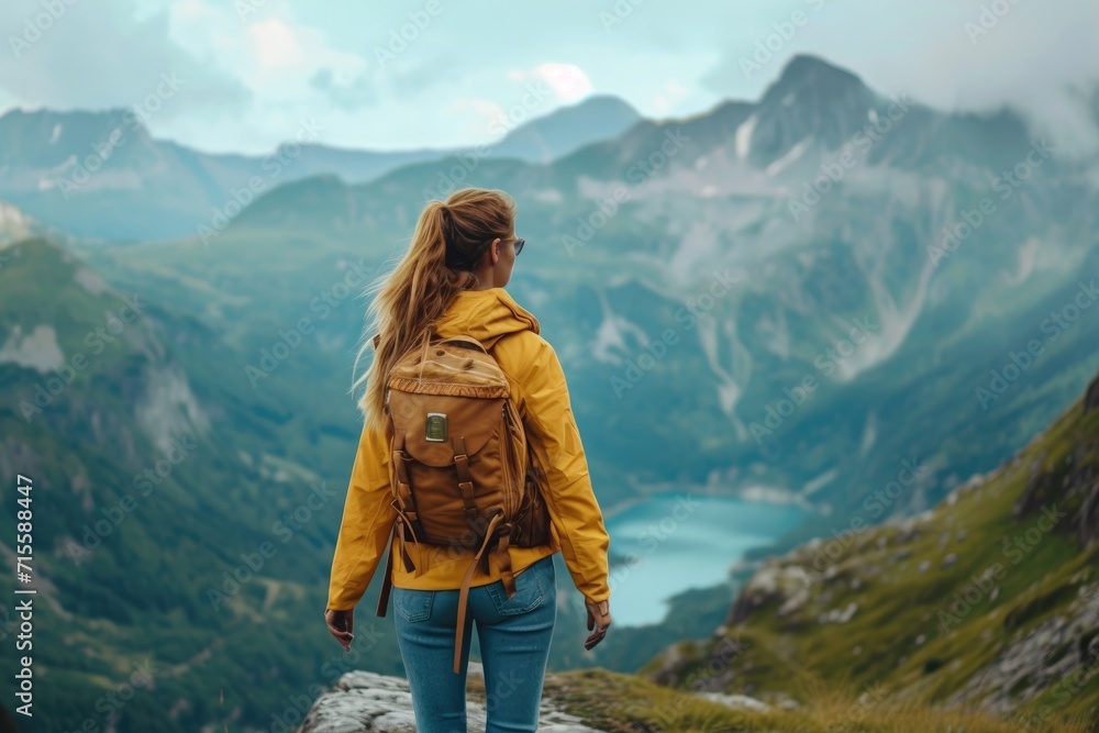 Active woman enjoys the beautiful scenery of the majestic mountains