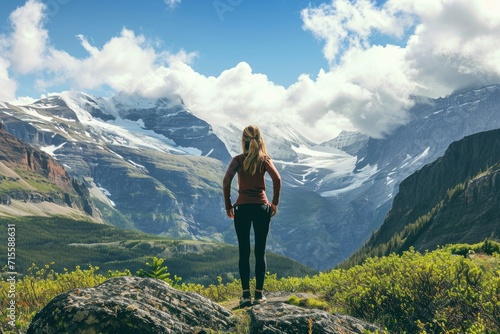 Active woman enjoys the beautiful scenery of the majestic mountains