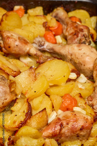 Chicken thighs with potatoes ready to eat.