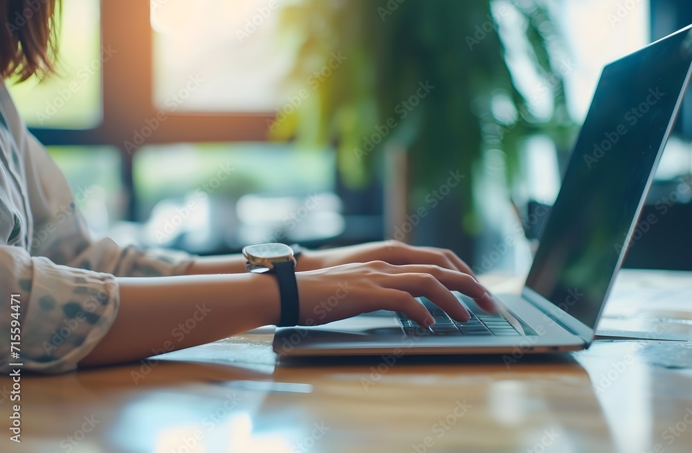 person working on a laptop desktop with a hand held device, person working on a laptop desktop with a hand held device,