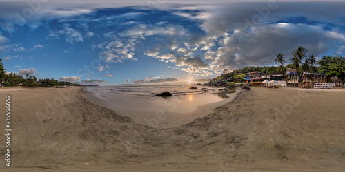 Fototapeta Naklejka Na Ścianę i Meble -  360 hdri panorama with coconut trees on ocean coast on beach at sunset in equirectangular spherical seamless projection