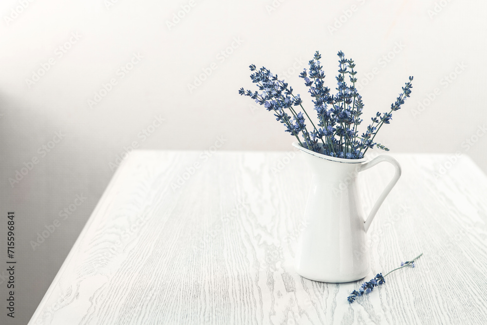 Bunch of Lavender in white vase on the wooden table