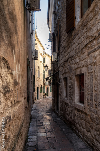 Morning walk along winding narrow streets with ancient stone buildings in the old town of Kotor, Montenegro © Jess_Ivanova