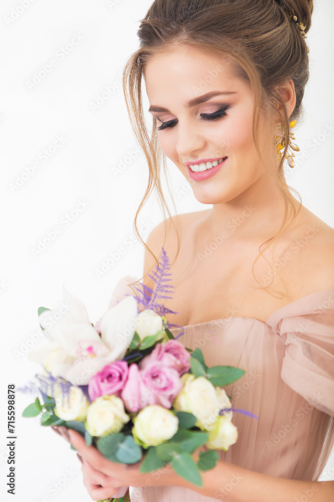 Young pretty bride with bridal bouquet indoors